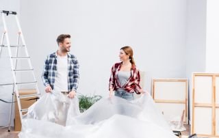 Een stel dat bezig is met Glasweefselbehang verwijderen.